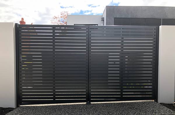 Aluminum alloy double swing electric gate on a sloped driveway