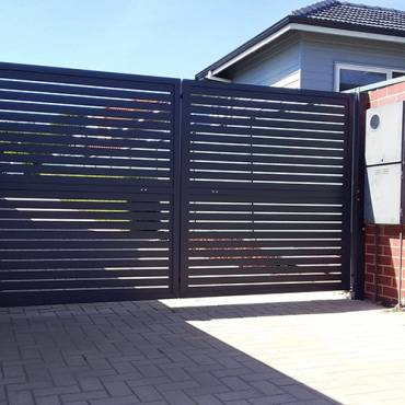 Auckland's custom black aluminum gate offers secure property access and modern curb appeal.