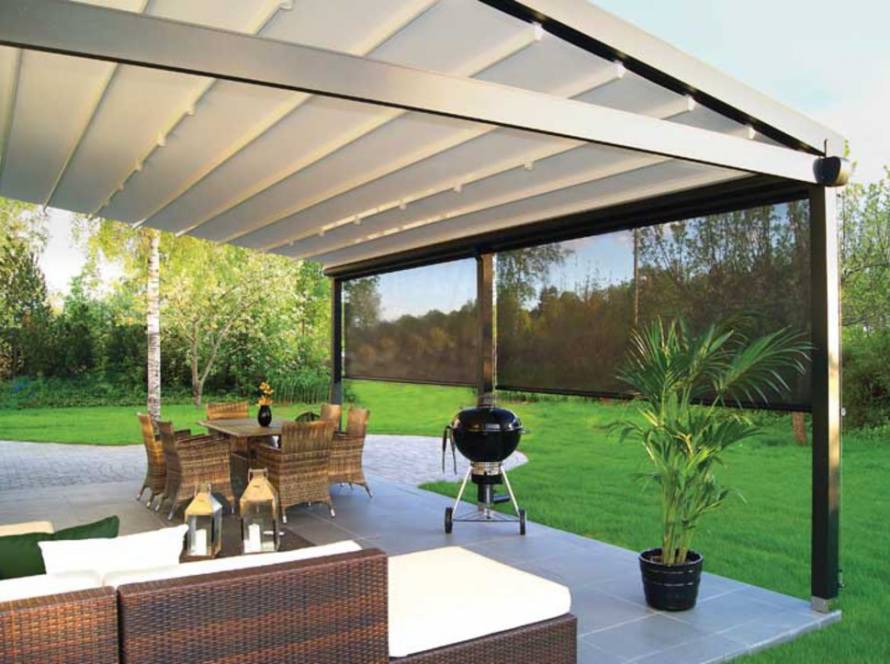 Outdoor living in Auckland: Homelovers retractable awning extended over a stylish patio with furniture and BBQ.