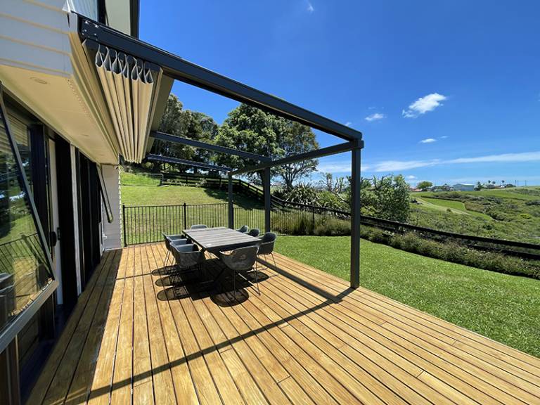 Homelovers awning for deck: Extended over a modern wooden deck, creating a comfortable outdoor living space in Auckland.