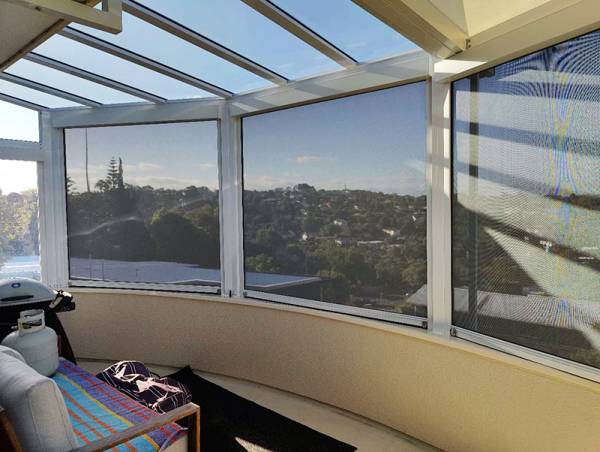 Windproof outdoor blinds installed on a balcony, offering shade, privacy, and reliable wind protection for comfortable outdoor living.