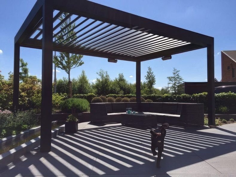 Custom black aluminium louvres installed in a sunny Auckland backyard, creating a comfortable and stylish outdoor living space.